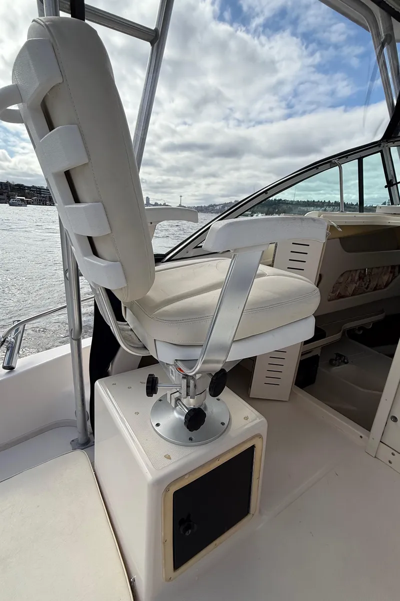 Slide: The Image of Captain's chair on 2001 Grady-White Sailfish 274 boat, overlooking water under cloudy sky. - 26