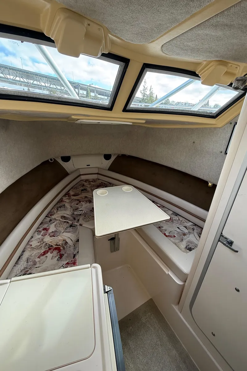 Slide: The Image of 2001 Grady-White Sailfish 274 cabin interior with table and windows. - 28