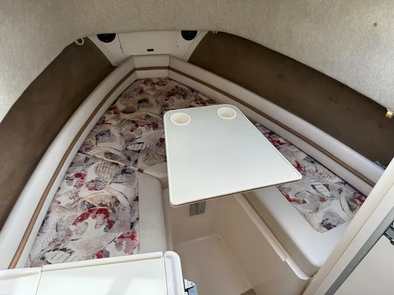 Slide: The Image of 2001 Grady-White Sailfish 274 cabin interior with patterned cushions and table. - 29