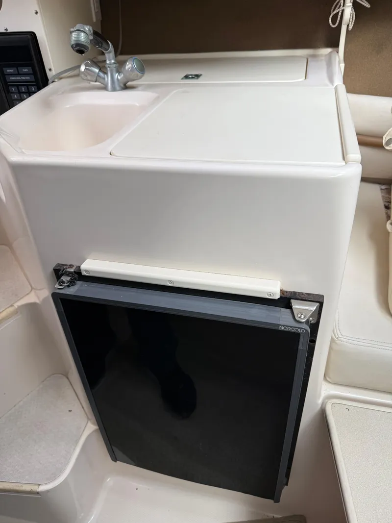 Slide: The Image of 2001 Grady-White Sailfish 274 boat interior with sink and mini fridge. - 31