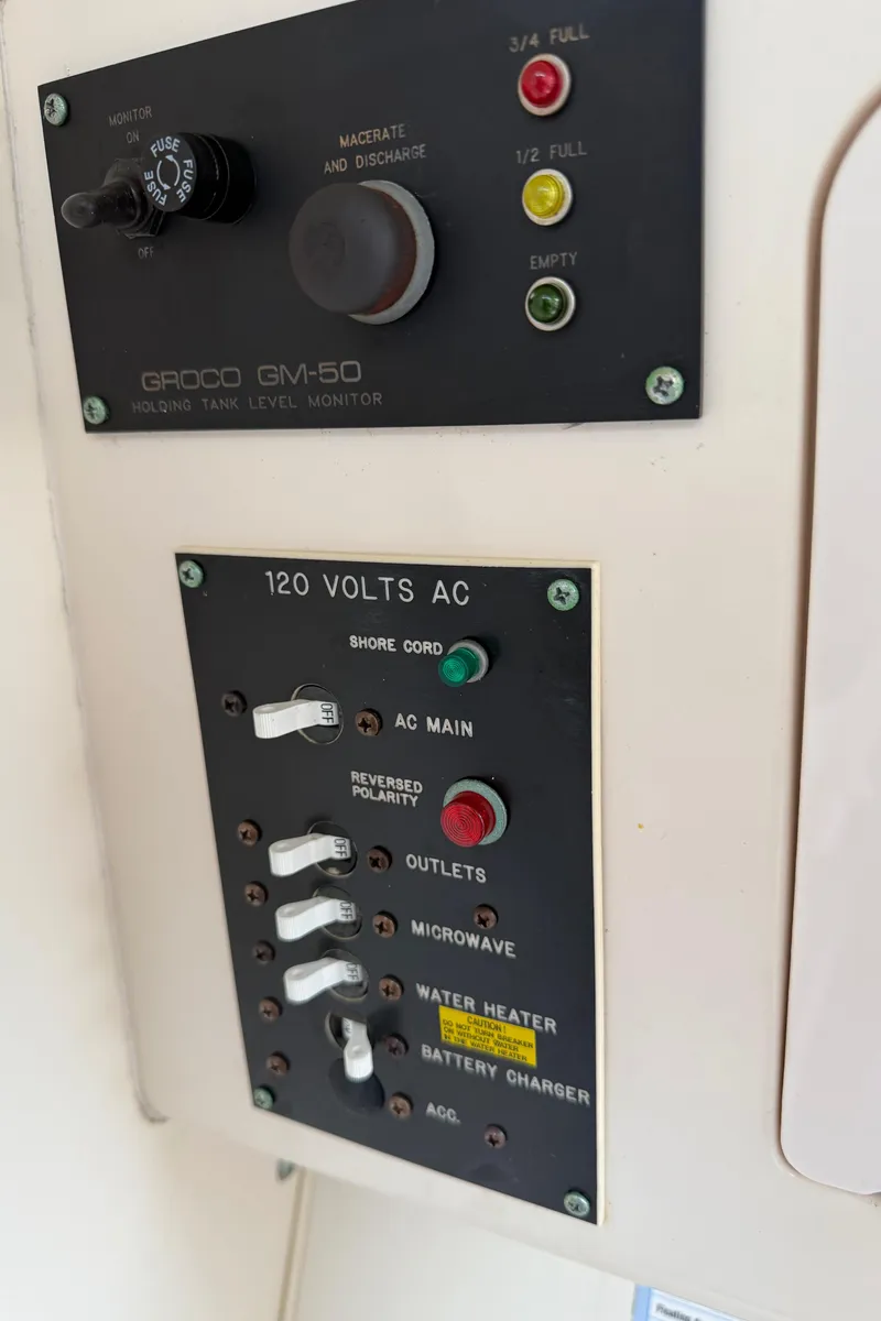 Slide: The Image of Control panel of a 2001 Grady-White Sailfish 274 boat, showing electrical switches and indicators. - 34