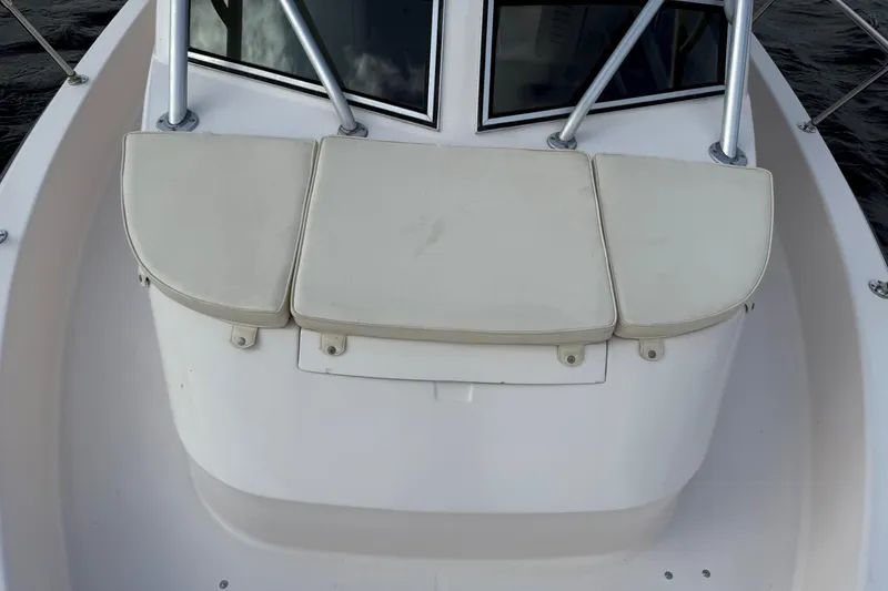 Slide: The Image of 2001 Grady-White Sailfish 274 boat seating area with cushioned seats. - 35