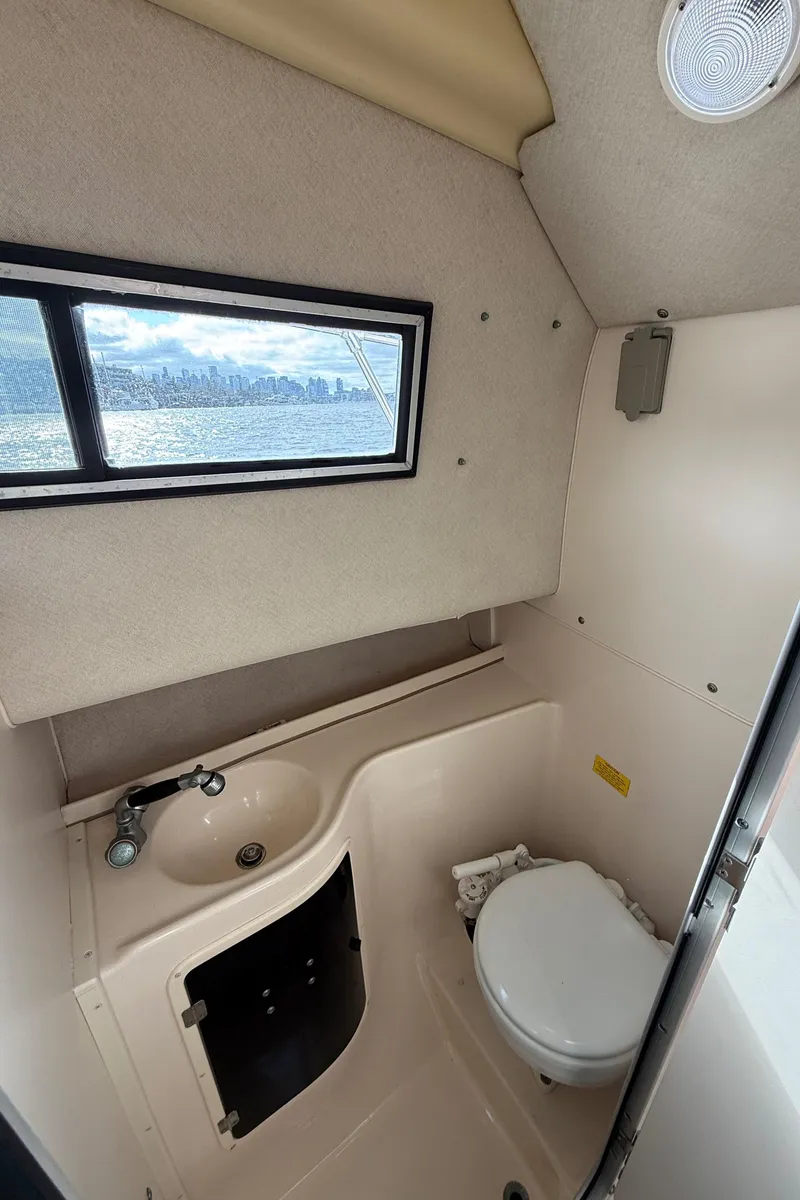 Slide: The Image of 2001 Grady-White Sailfish 274 boat interior with sink, toilet, and window view. - 39