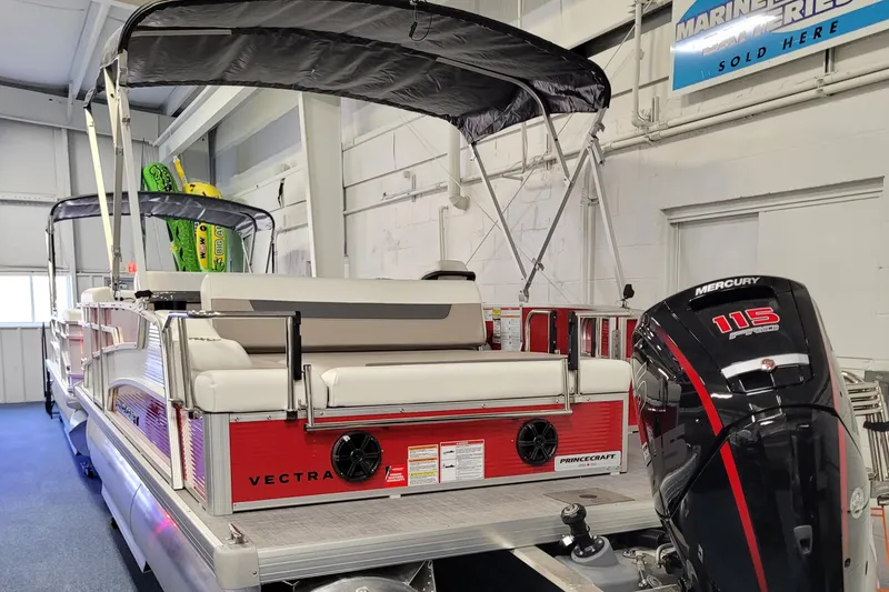 Slide: The Image of 2025 Princecraft Vectra 21 RL pontoon boat with Mercury 115 engine in showroom. - 11