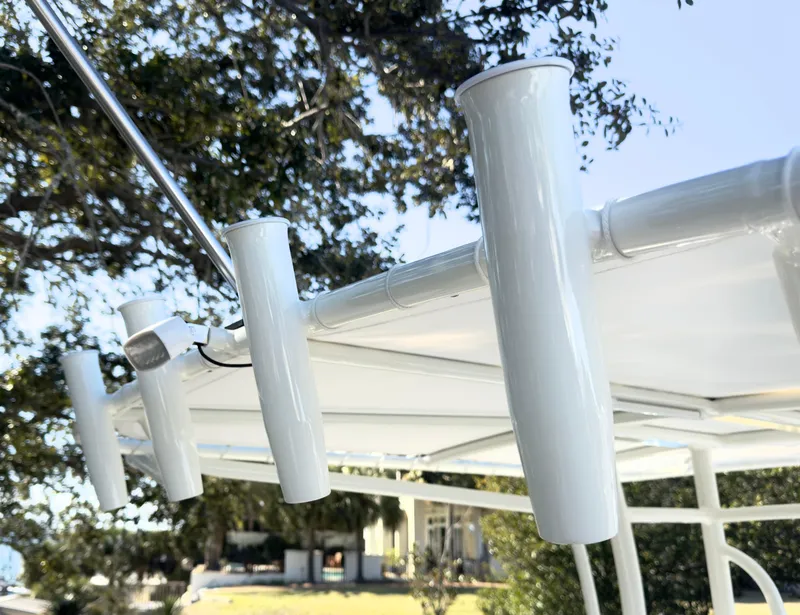 Slide: The Image of Rod holders on a 2025 Pathfinder 2200TRS boat, with a scenic outdoor background. - 16