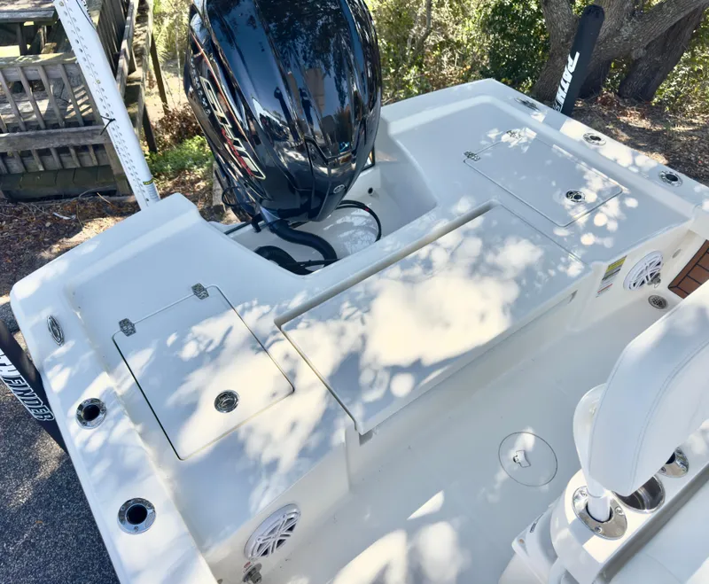 Slide: The Image of 2025 Pathfinder 2200TRS boat deck with motor, storage compartments, and seating. - 7