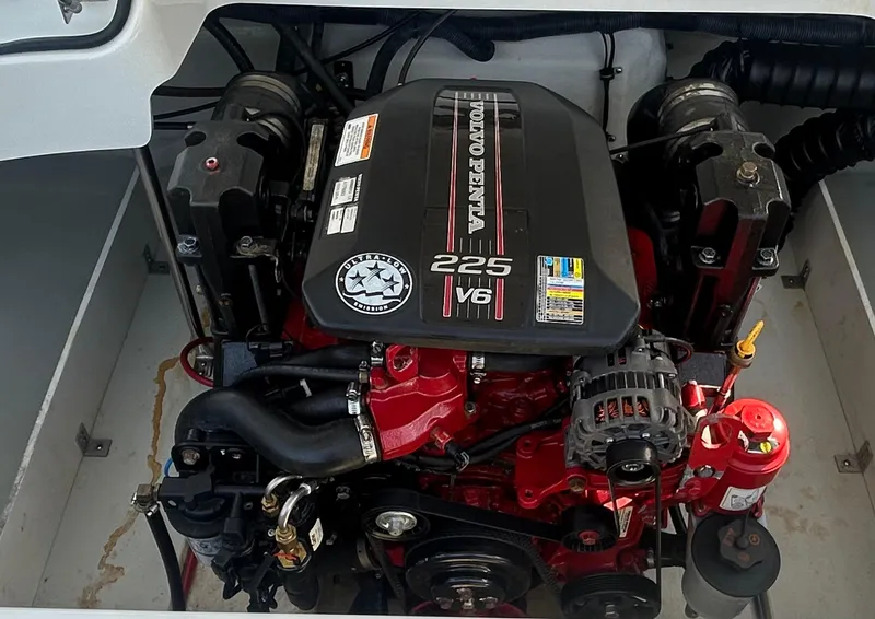 Slide: The Image of 2012 Cobalt 210 WSS boat engine, featuring a 225 V6 motor in a clean compartment. - 11