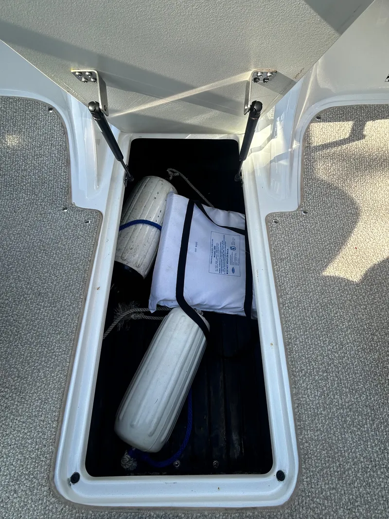 Slide: The Image of Storage compartment of a 2012 Cobalt 210 WSS boat with safety equipment. - 5