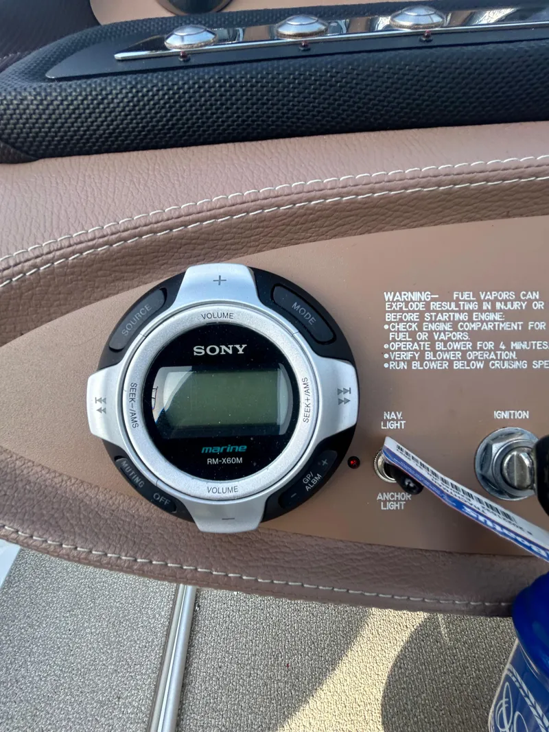 Slide: The Image of Sony marine stereo on 2012 Cobalt 210 WSS boat dashboard with warning label. - 6