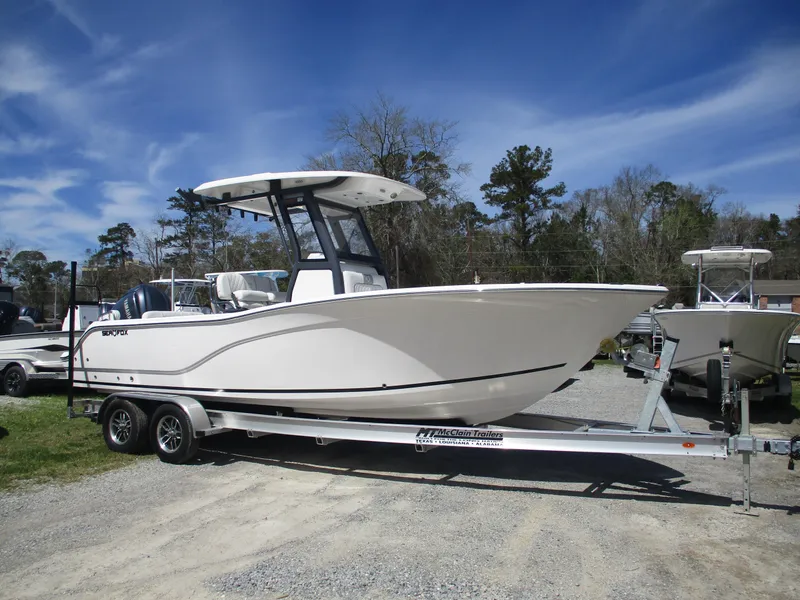 Slide: The Image of 2025 Sea Fox 248 Commander boat on trailer, parked outdoors under a clear blue sky. - 0