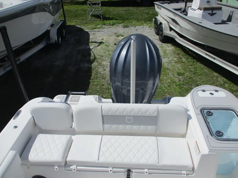 Slide: The Image of 2025 Sea Fox 248 Commander boat with white seating and outboard motor. - 11