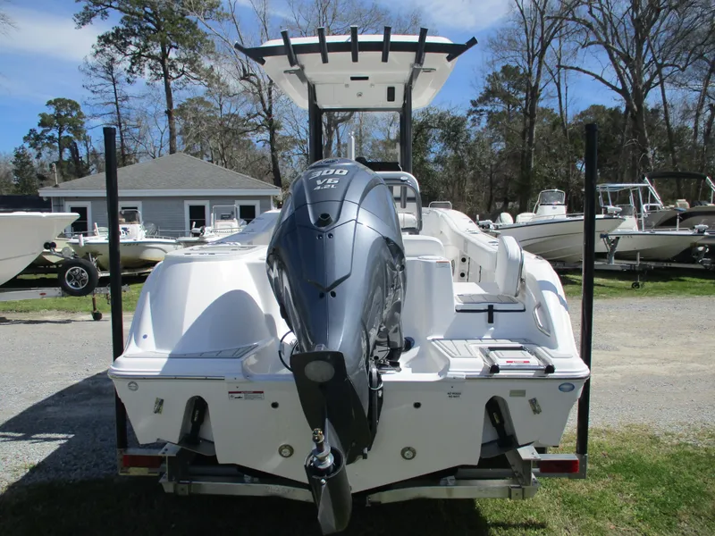 Slide: The Image of 2025 Sea Fox 248 Commander boat with powerful outboard motor, parked outdoors. - 17