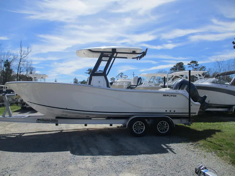 Slide: The Image of 2025 Sea Fox 248 Commander boat on trailer under clear blue sky. - 2