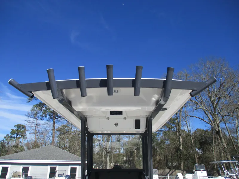 Slide: The Image of 2025 Sea Fox 248 Commander boat top view with rod holders against clear blue sky. - 3
