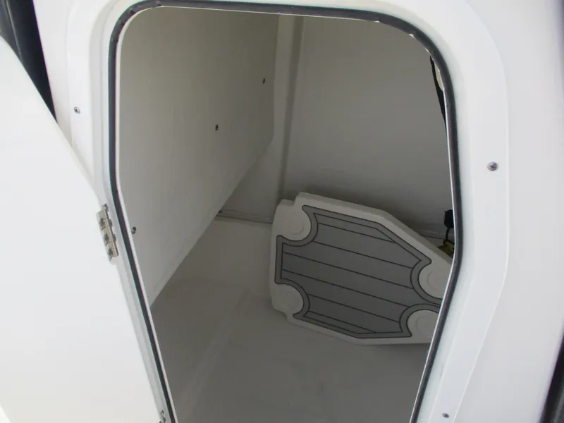 Slide: The Image of 2025 Sea Fox 248 Commander storage compartment with open door. - 4