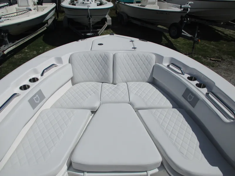 Slide: The Image of 2025 Sea Fox 248 Commander boat with white cushioned seating and cup holders. - 7