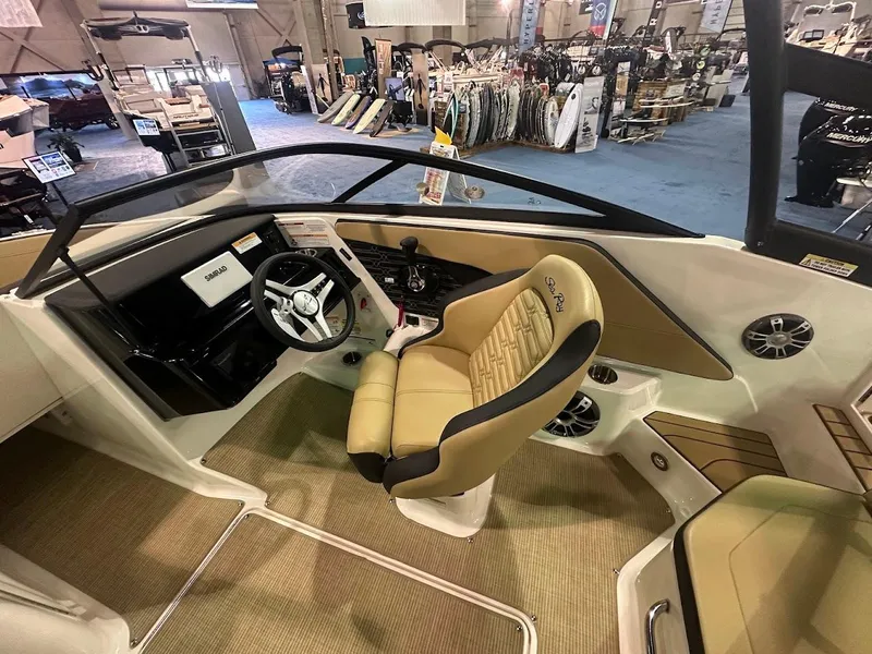 Slide: The Image of Interior of 2025 Sea Ray SPX 190 boat with tan seating and modern dashboard. - 14