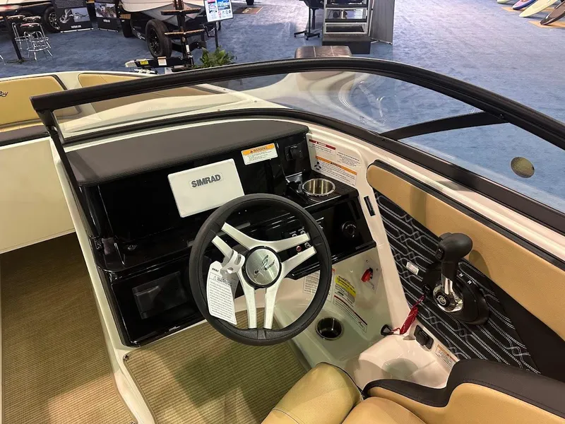 Slide: The Image of Interior view of 2025 Sea Ray SPX 190 boat, featuring steering wheel and control panel. - 15