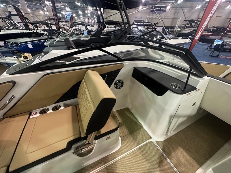 Slide: The Image of 2025 Sea Ray SPX 190 boat interior with tan seating and modern dashboard. - 17