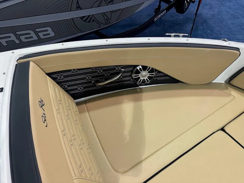 Slide: The Image of 2025 Sea Ray SPX 190 boat interior with beige seating and speaker detail. - 19