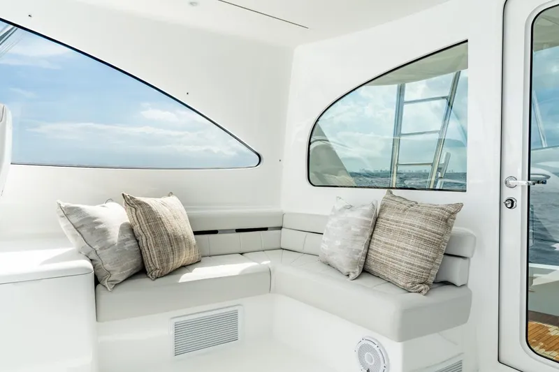 Slide: The Image of Luxurious interior of 2025 Viking 54 Sport Tower yacht with plush seating and ocean view. - 37