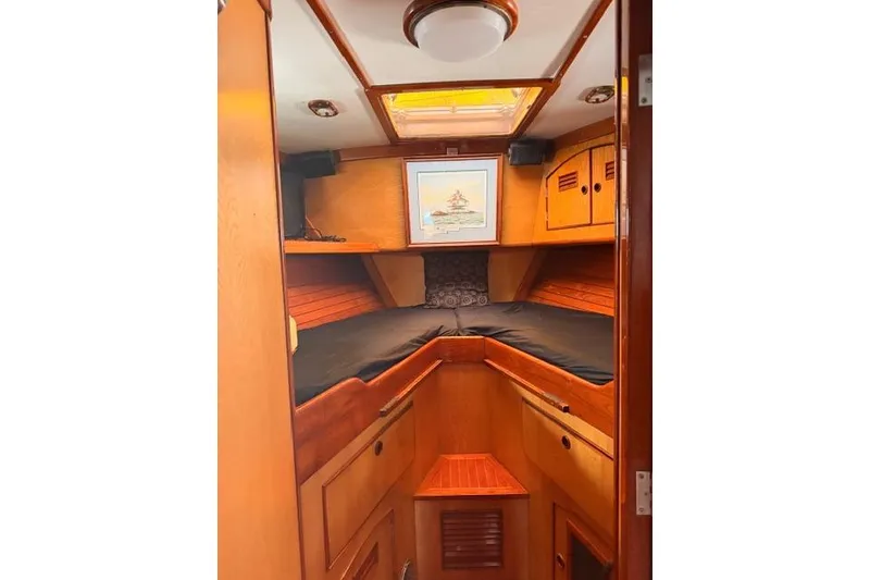 Slide: The Image of Interior cabin of 1981 Little Harbor custom sailboat with wooden finish and cozy bedding. - 13