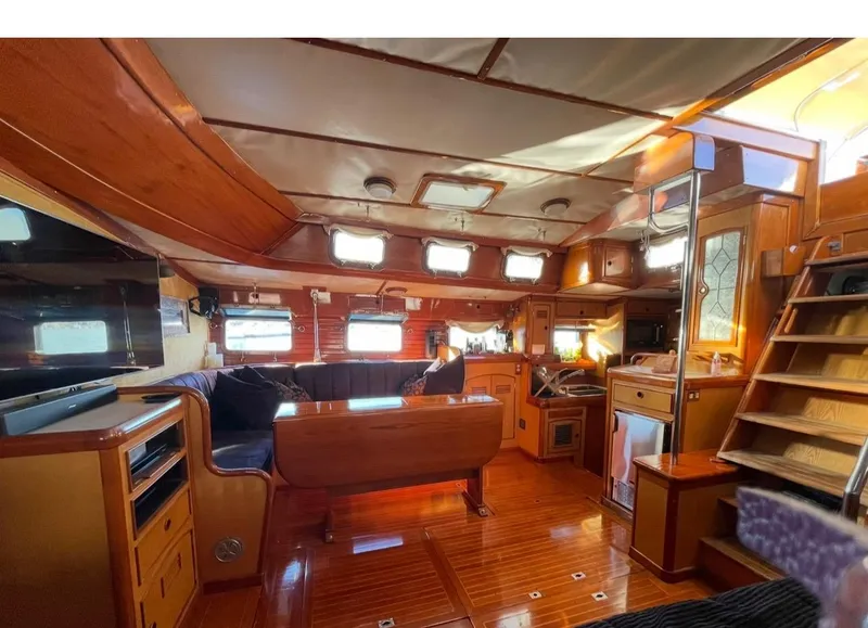Slide: The Image of Interior of 1981 Little Harbor Cruiser with wooden furnishings and cozy seating area. - 6