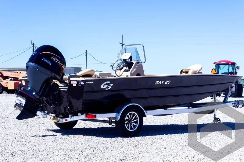 Slide: The Image of 2025 G3 Bay 20 boat with Yamaha motor on a trailer in a gravel lot. - 17