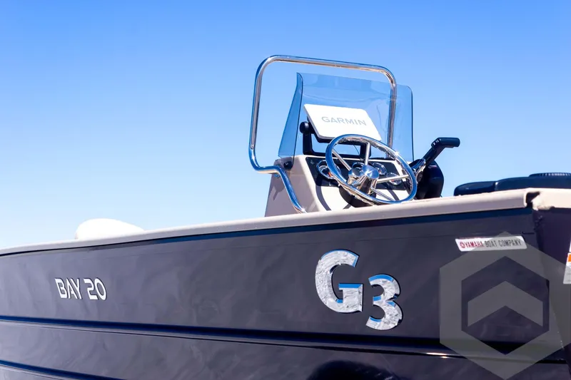 Slide: The Image of 2025 G3 Bay 20 boat with steering wheel and Garmin equipment. - 22
