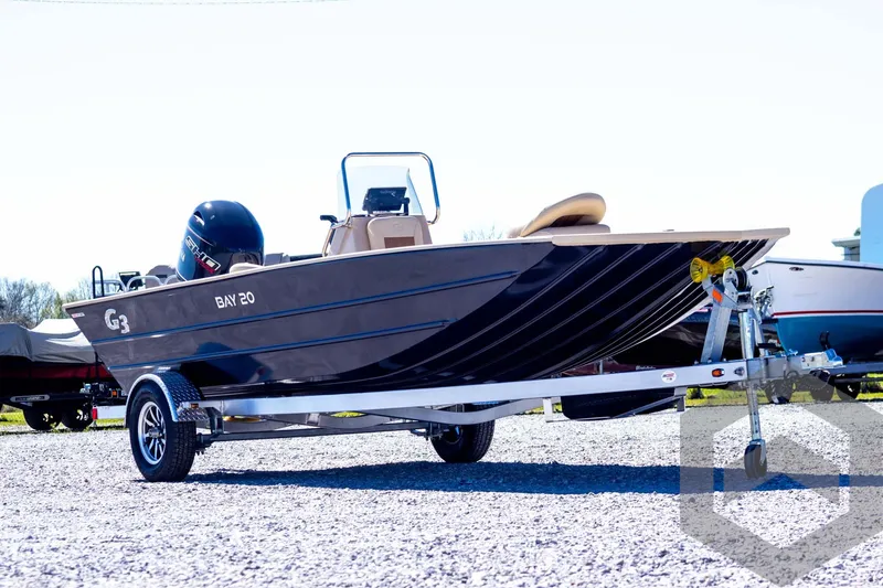 Slide: The Image of 2025 G3 Bay 20 boat on trailer, parked outdoors, side view. - 3