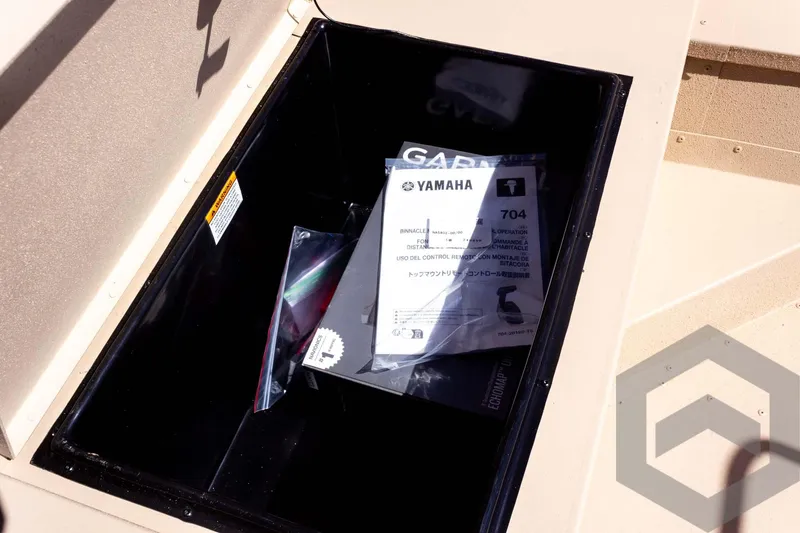 Slide: The Image of Storage compartment in 2025 G3 Bay 20 boat with Yamaha manual inside. - 30