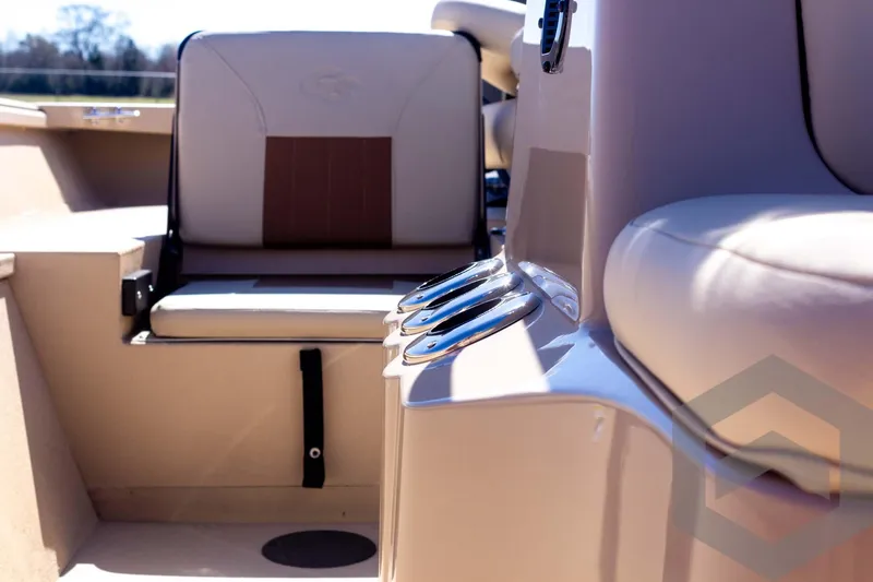 Slide: The Image of 2025 G3 Bay 20 boat interior with beige seating and cup holders. - 37