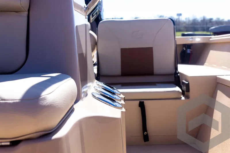 Slide: The Image of 2025 G3 Bay 20 boat interior with cushioned seating and cup holders. - 38