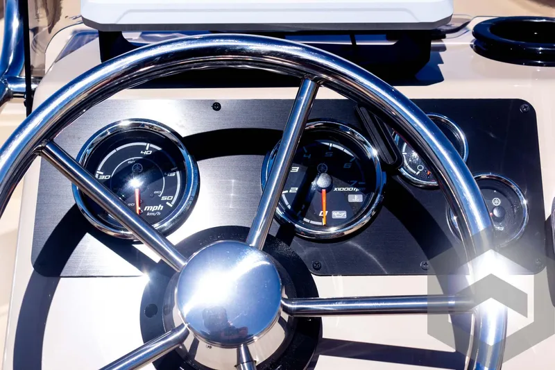 Slide: The Image of Steering wheel and dashboard of 2025 G3 Bay 20 boat, featuring modern gauges. - 43