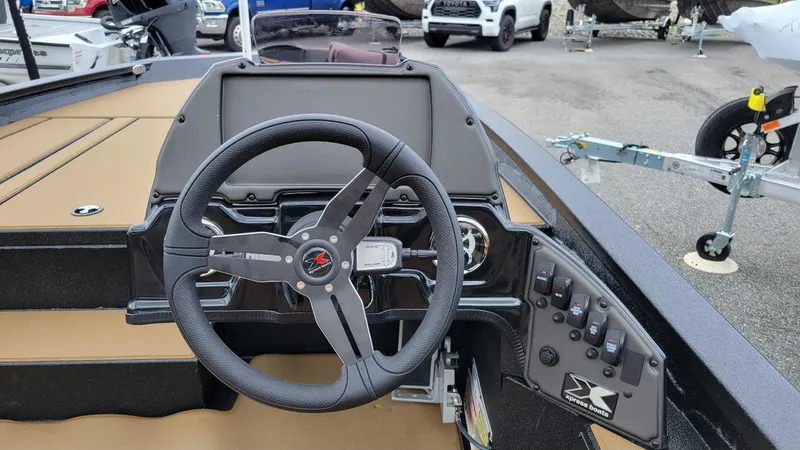 Slide: The Image of 2026 Xpress H20 Bass boat dashboard with steering wheel and control panel. - 17