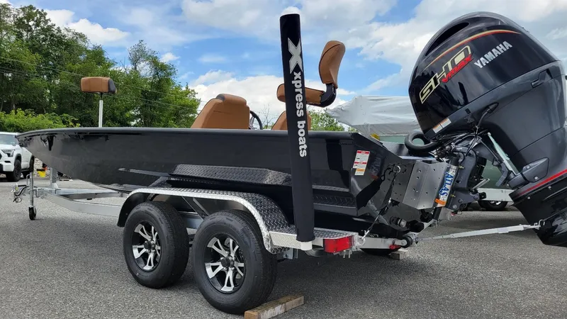 Slide: The Image of 2026 Xpress H20 Bass boat with Yamaha Vmax 175 engine, parked on a trailer. - 9