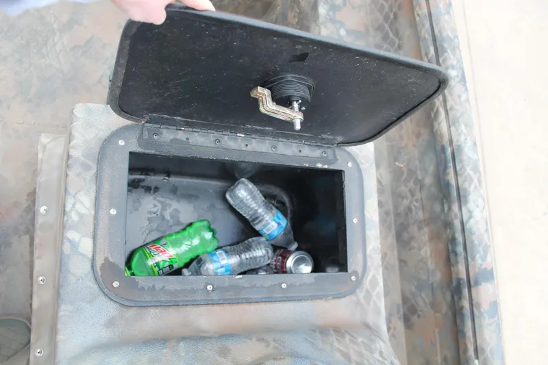 Slide: The Image of Storage compartment in 2023 Excel Catfish Pro 21 boat with bottles and cans. - 11