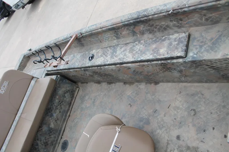 Slide: The Image of 2023 Excel Catfish Pro 21 Side Console interior with camo design and seating. - 12