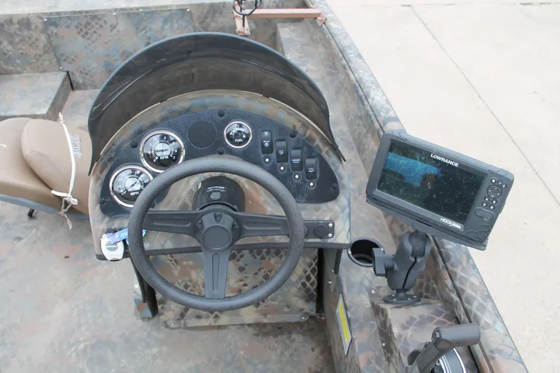 Slide: The Image of 2023 Excel Catfish Pro 21 Side Console dashboard with steering wheel and navigation display. - 19