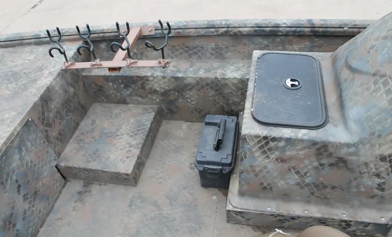 Slide: The Image of 2023 Excel Catfish Pro 21 Side Console interior with rod holders and storage compartments. - 22