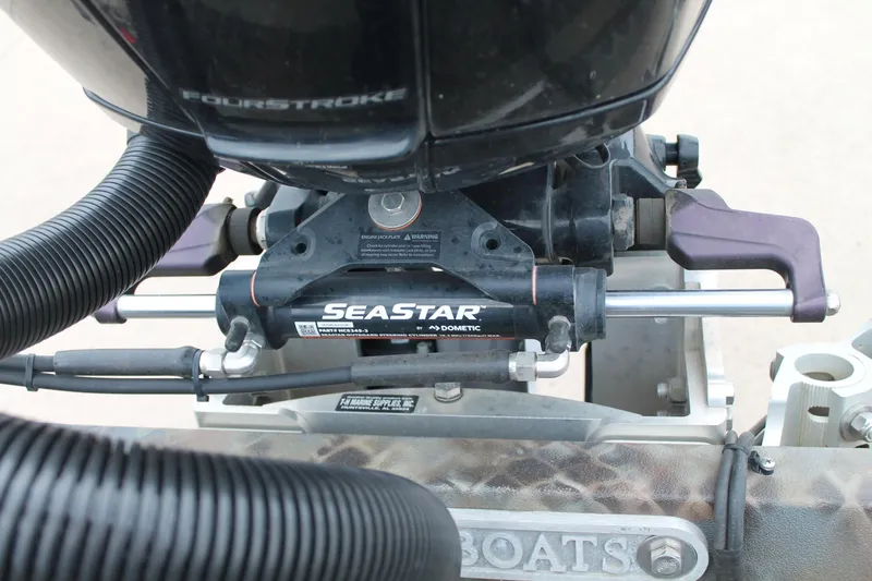 Slide: The Image of Close-up of SeaStar hydraulic steering on 2023 Excel Catfish Pro 21 Side Console boat. - 24