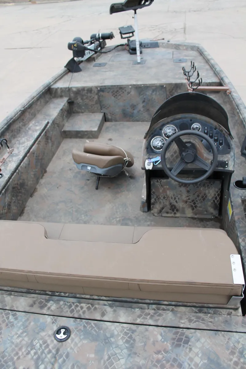 Slide: The Image of 2023 Excel Catfish Pro 21 Side Console boat interior with steering wheel and seating. - 26