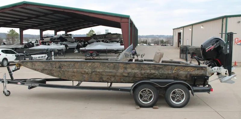 Slide: The Image of 2023 Excel Catfish Pro 21 Side Console boat on trailer, parked outdoors. - 3