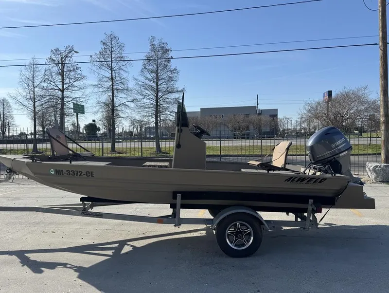 Slide: The Image of 2024 Alweld 1752 Marsh boat on trailer, parked outdoors, side view. - 7
