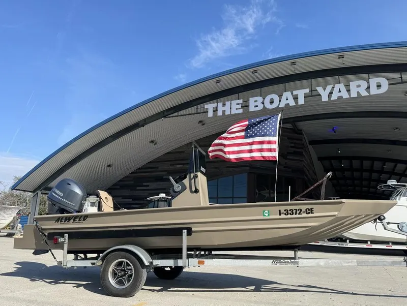 Slide: The Image of 2024 Alweld 1752 Marsh boat with American flag at The Boat Yard. - 9