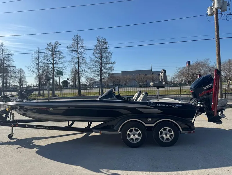 Slide: The Image of 2007 Ranger Z21 Comanche boat with Yamaha engine on trailer, parked outdoors. - 15