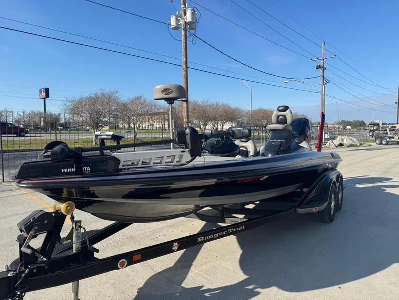Slide: The Image of 2007 Ranger Z21 Comanche boat on trailer, parked outdoors under clear blue sky. - 16