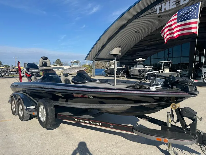 Slide: The Image of 2007 Ranger Z21 Comanche boat on trailer, parked outside dealership with American flag. - 17