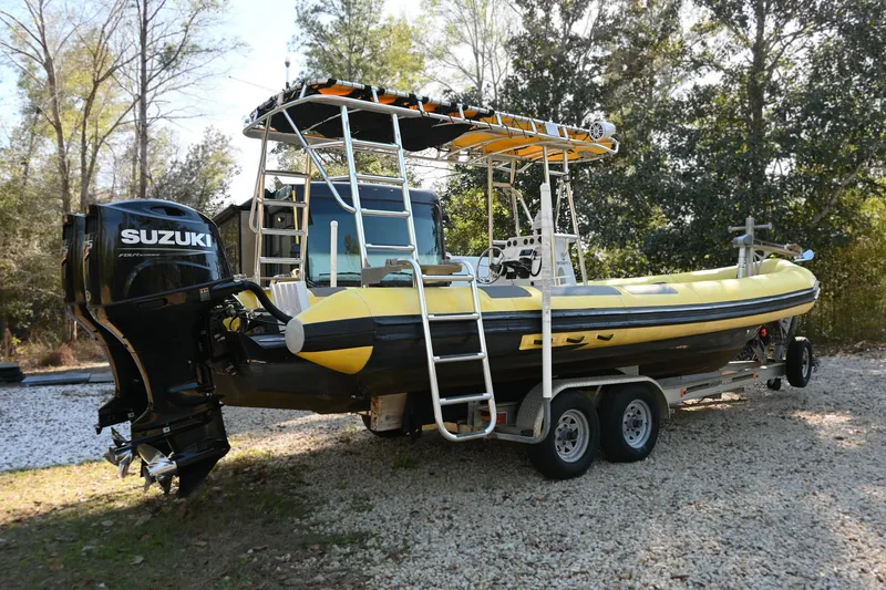 The Image of 2007 Ribcraft 9.0 boat with Suzuki outboard motor on a trailer. - 0