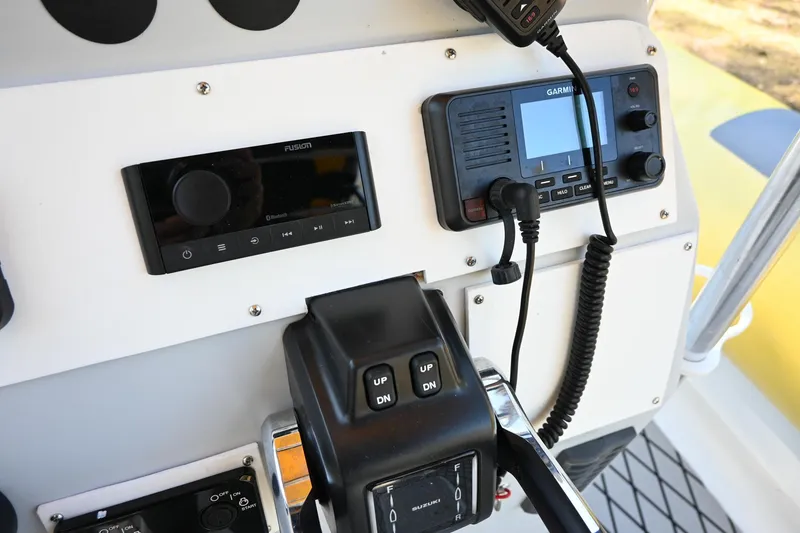 Slide: The Image of Control panel of a 2007 Ribcraft 9.0 boat with Garmin and Fusion devices. - 12